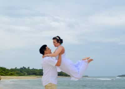 groom throwing bride in air