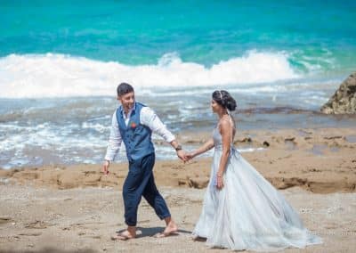 bride and groom walk on beach mexico